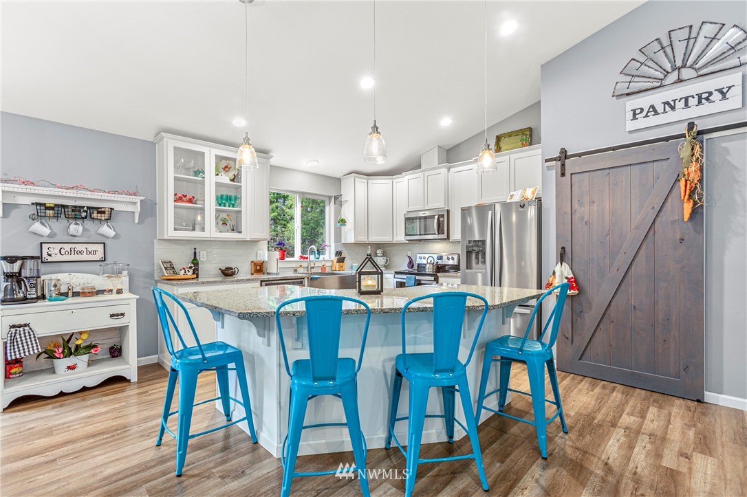 19614 Lerch Road Snohomish, WA 98290 - Photo 6 of 40 a dining room with stainless steel appliances a table and chairs