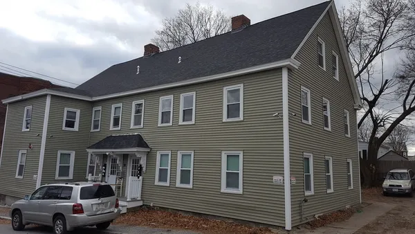 a front view of a house with parking space