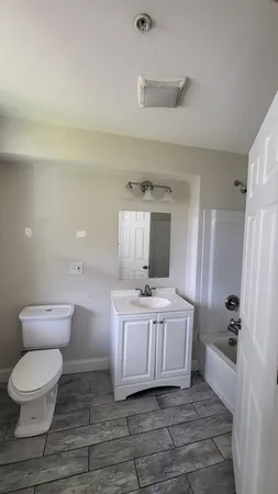 a large white room with a toilet