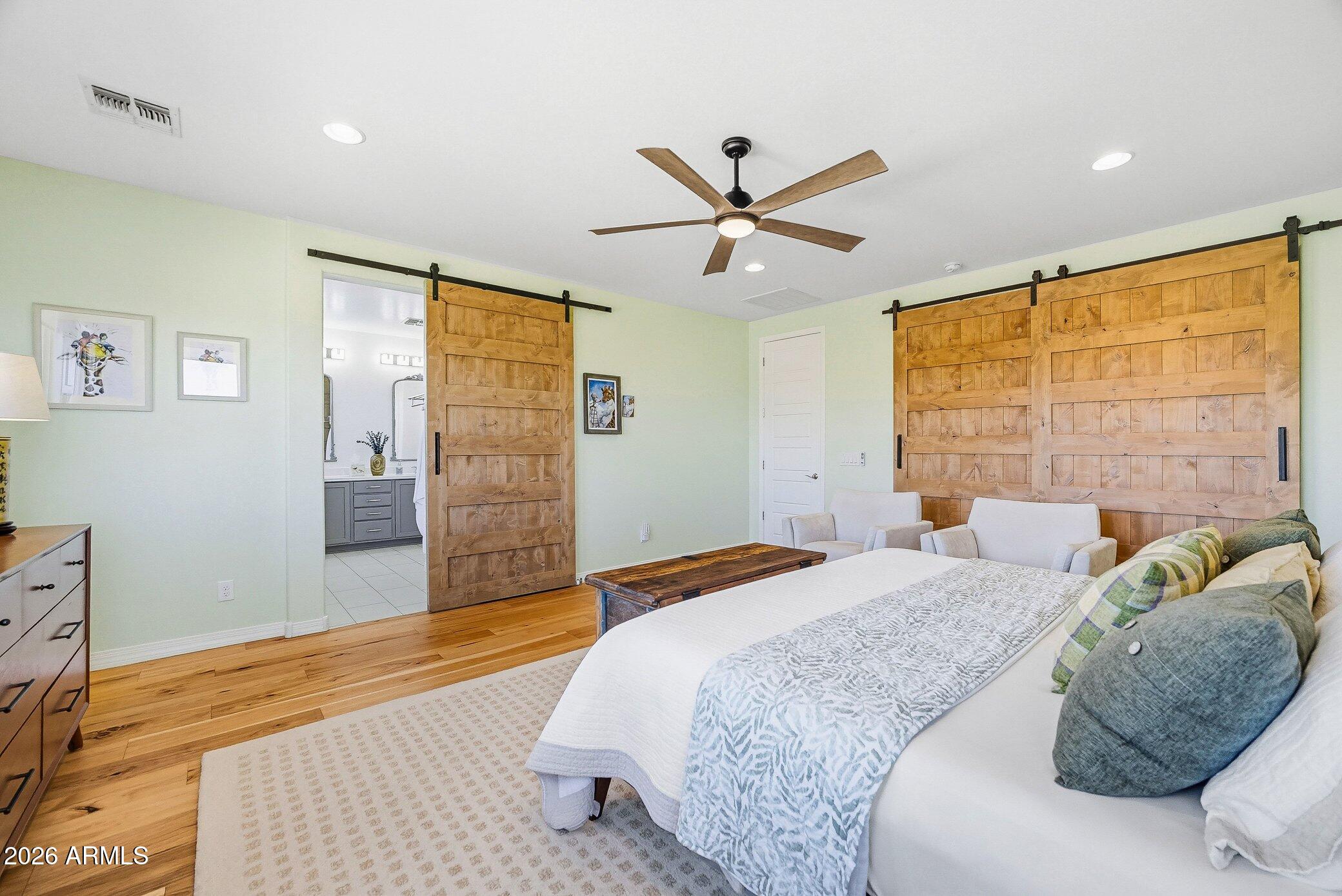 5819 South Wilson Way Gilbert, AZ 85298 - Photo 13 of 76 a bedroom with a large bed and a ceiling fan