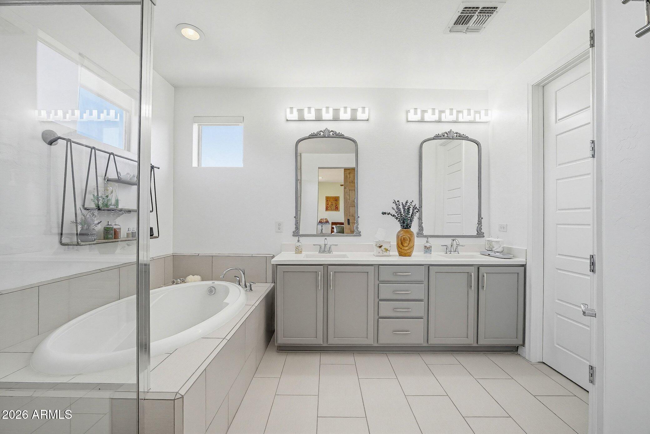5819 South Wilson Way Gilbert, AZ 85298 - Photo 14 of 76 a spacious bathroom with a tub sink and mirror