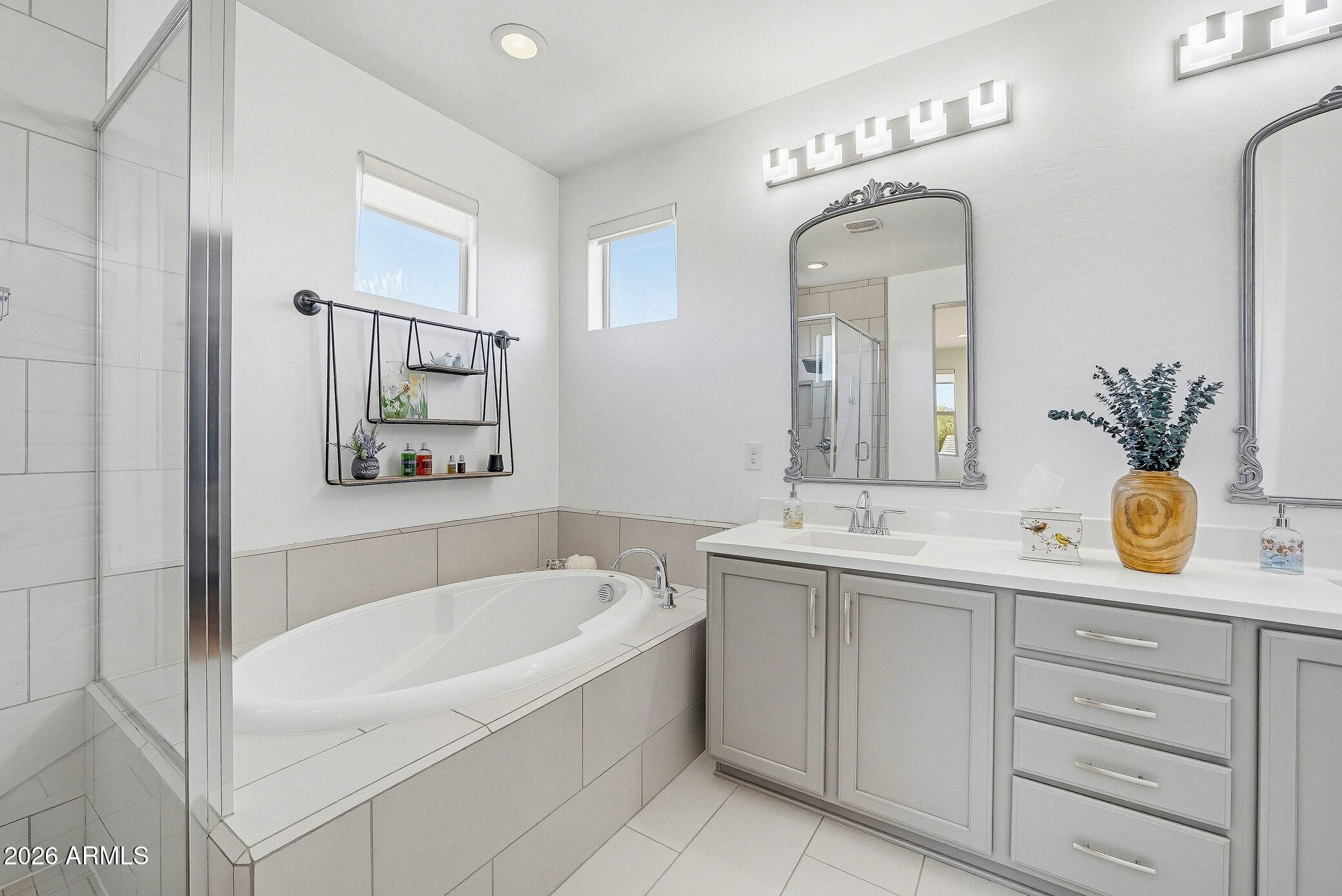 5819 South Wilson Way Gilbert, AZ 85298 - Photo 15 of 76 a bathroom with 2 sink tub and a mirror
