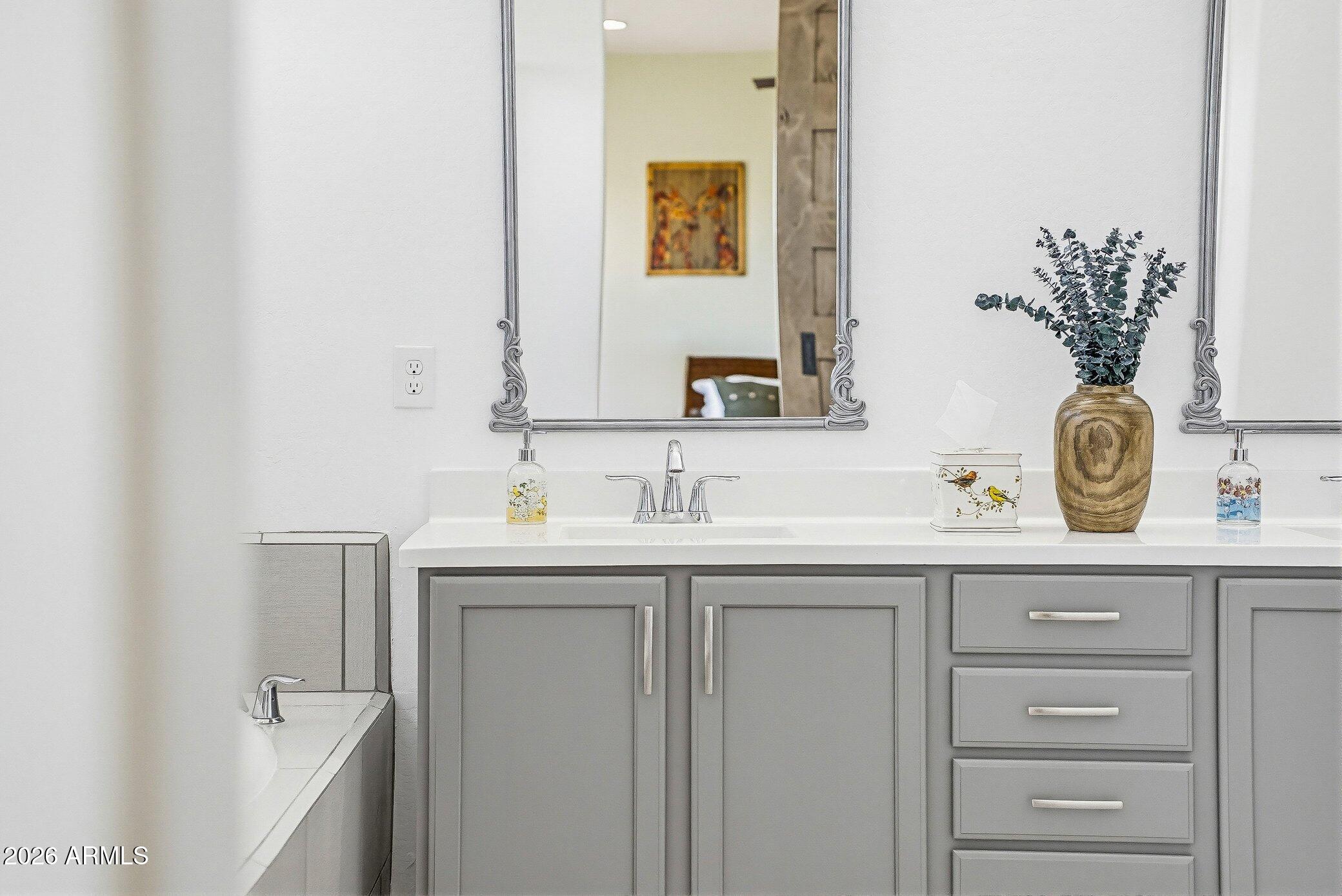 5819 South Wilson Way Gilbert, AZ 85298 - Photo 16 of 76 a bathroom with a sink and a mirror