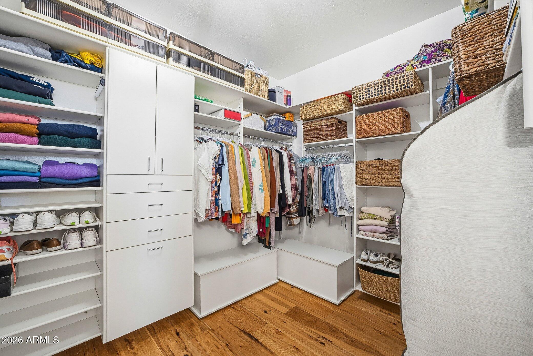 5819 South Wilson Way Gilbert, AZ 85298 - Photo 18 of 76 a view of walk in closet with clothes and shoes