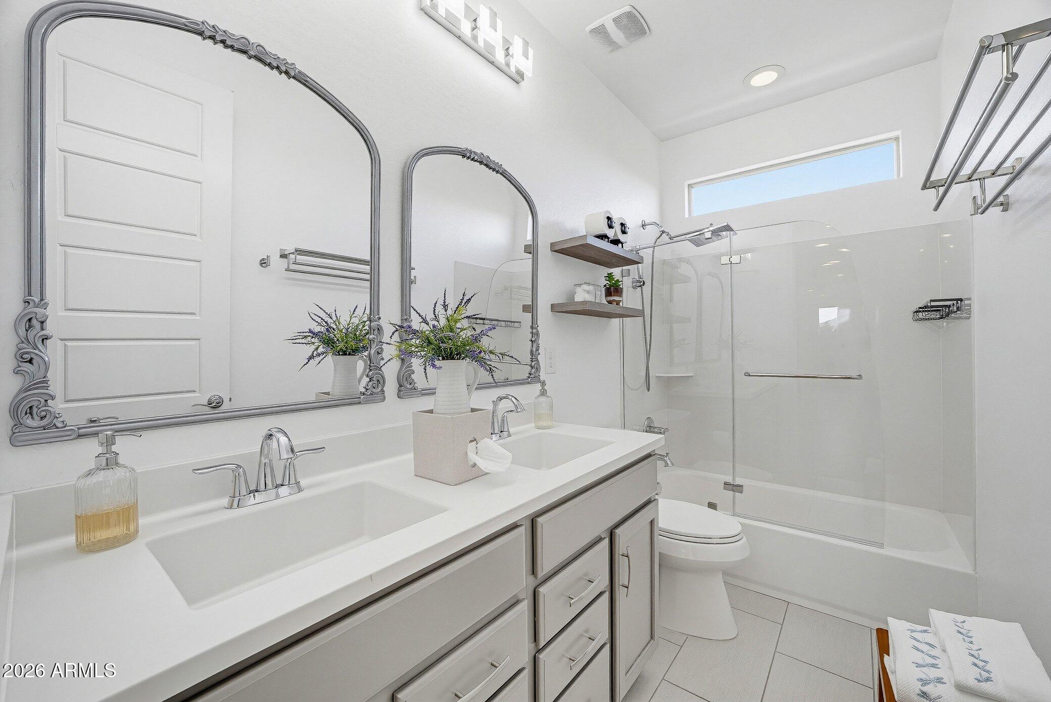 5819 South Wilson Way Gilbert, AZ 85298 - Photo 20 of 76 a bathroom with a double vanity sink toilet and shower