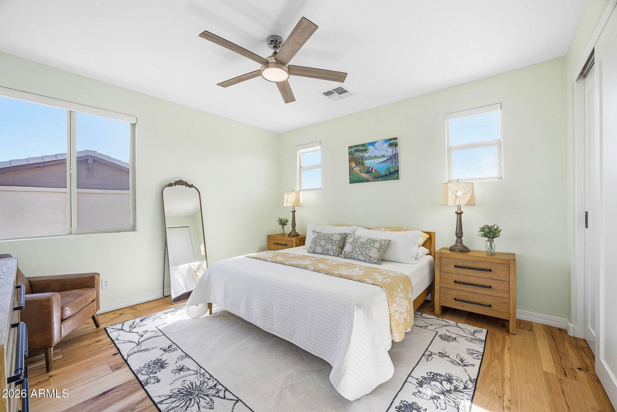 5819 South Wilson Way Gilbert, AZ 85298 - Photo 21 of 76 a bedroom with a large bed and a chandelier