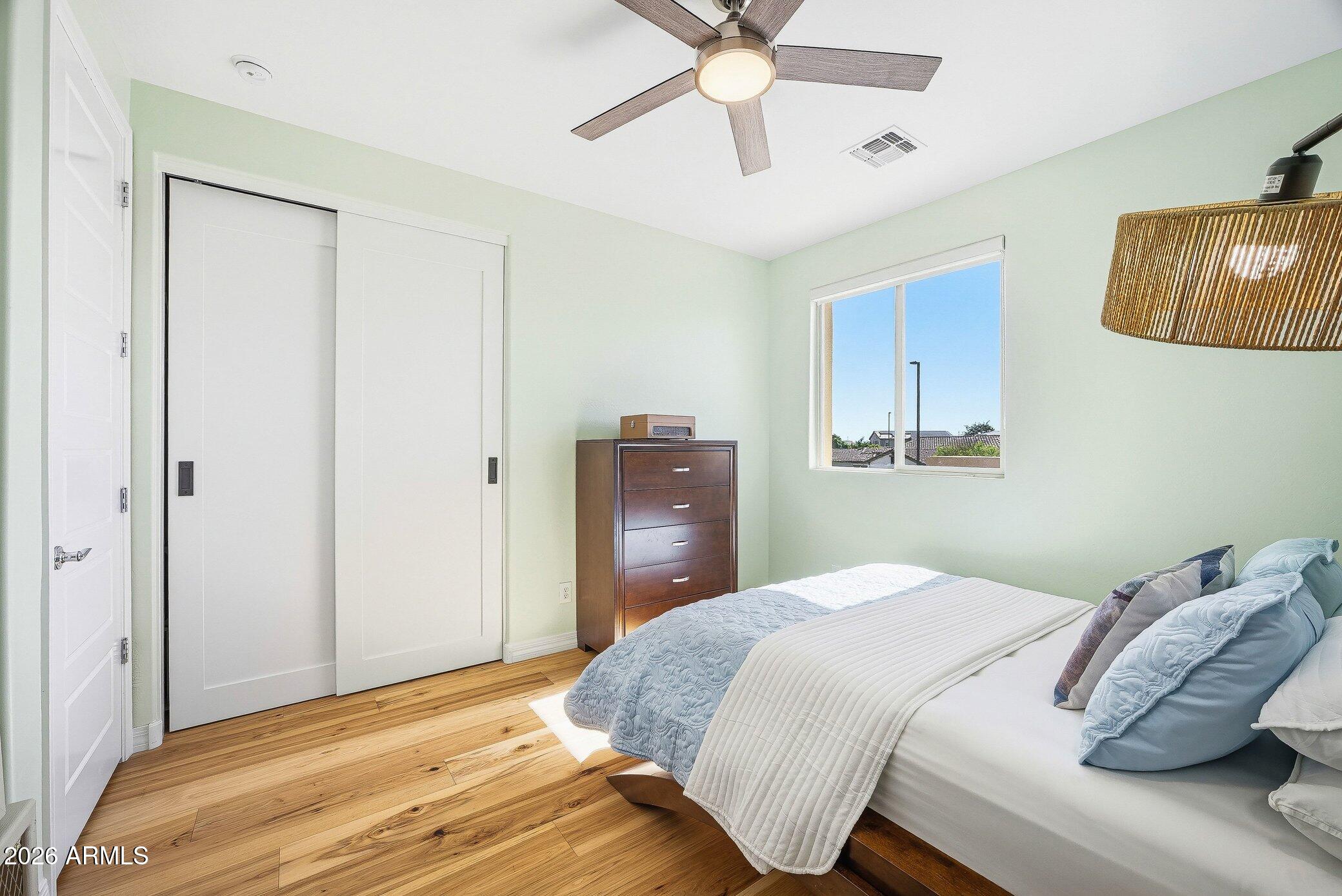 5819 South Wilson Way Gilbert, AZ 85298 - Photo 23 of 76 a bedroom with a bed and a painting on the wall