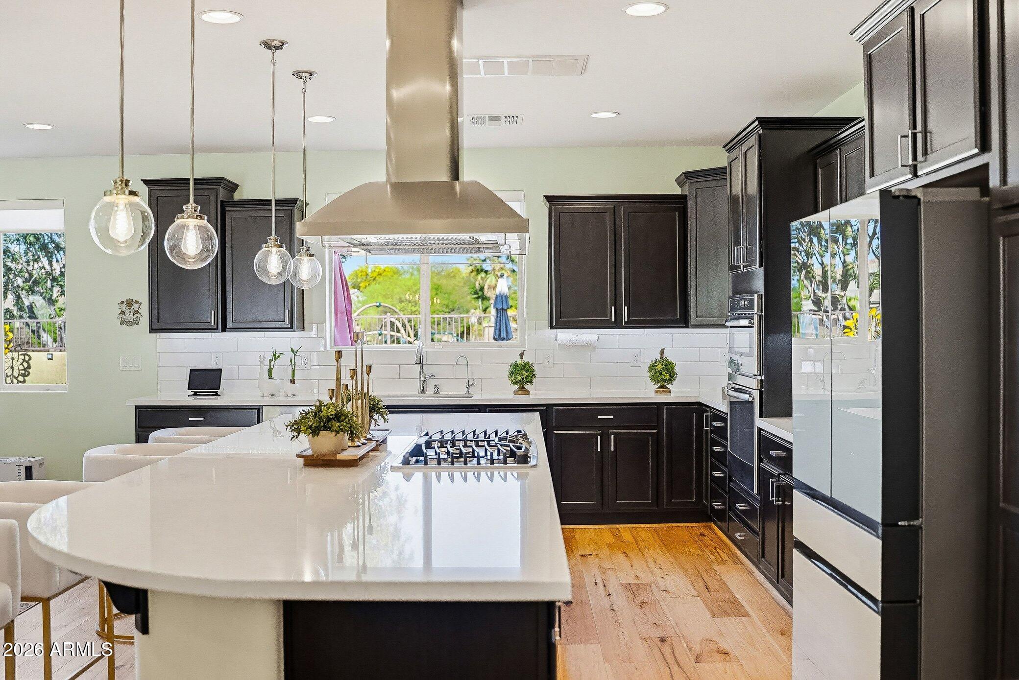 5819 South Wilson Way Gilbert, AZ 85298 - Photo 2 of 76 a kitchen with a sink appliances and cabinets