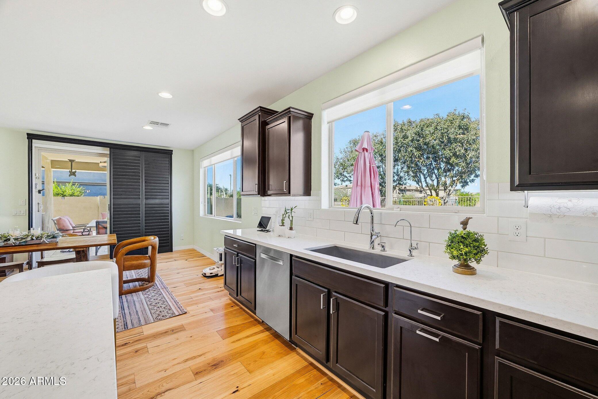 5819 South Wilson Way Gilbert, AZ 85298 - Photo 35 of 76 a kitchen with stainless steel appliances a sink stove and cabinets