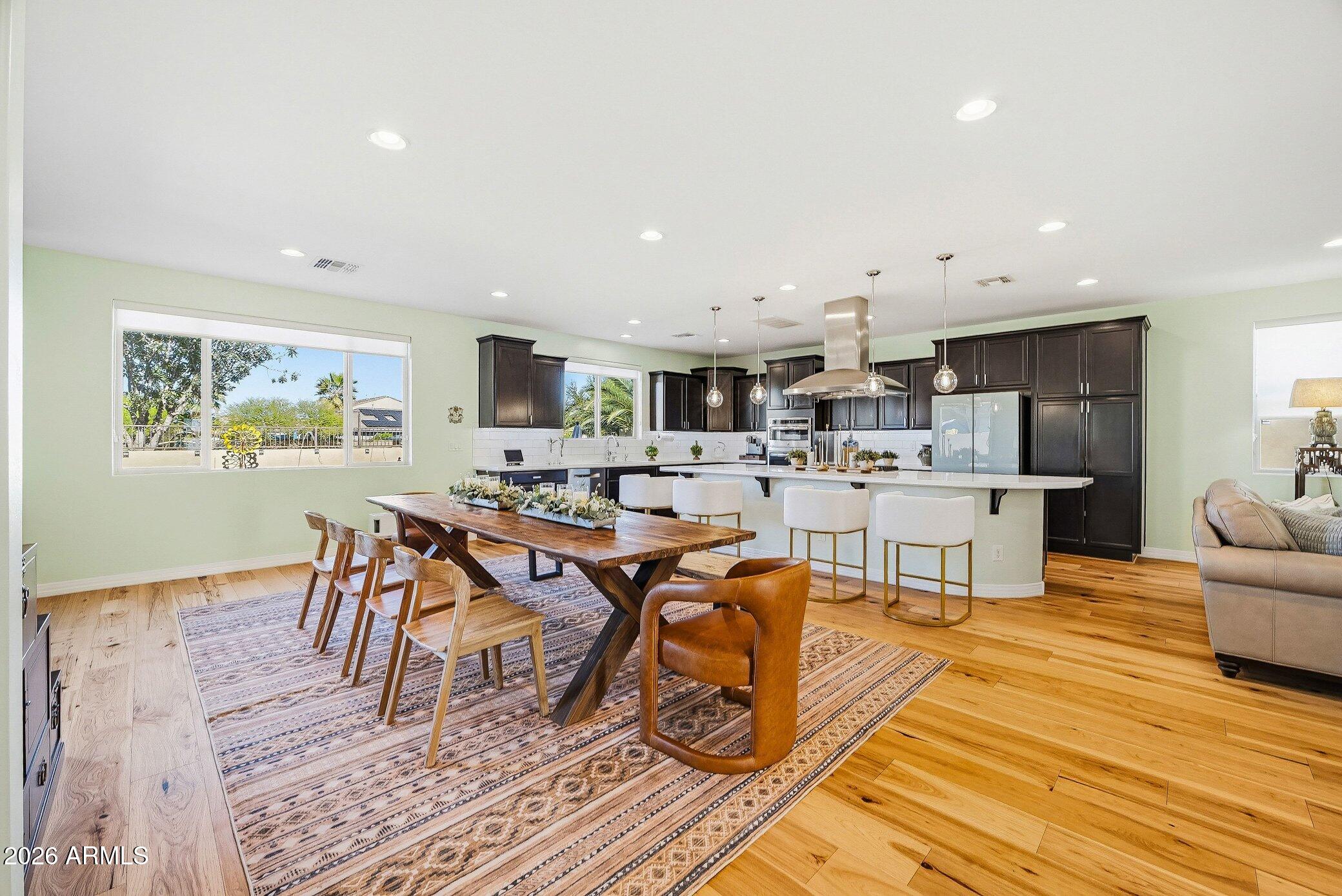 5819 South Wilson Way Gilbert, AZ 85298 - Photo 38 of 76 a living room with dining room and wooden floor