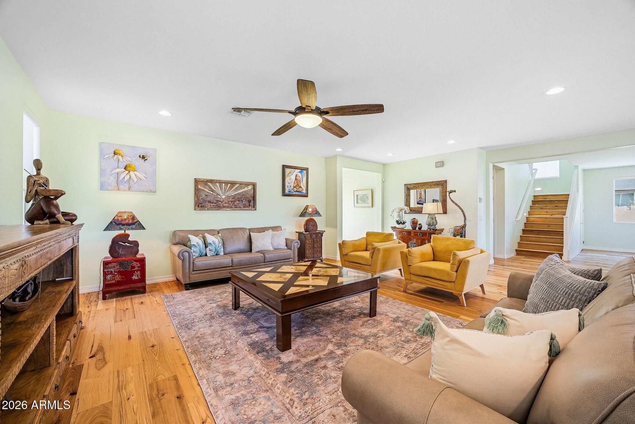 5819 South Wilson Way Gilbert, AZ 85298 - Photo 40 of 76 a living room with furniture and a wooden floor