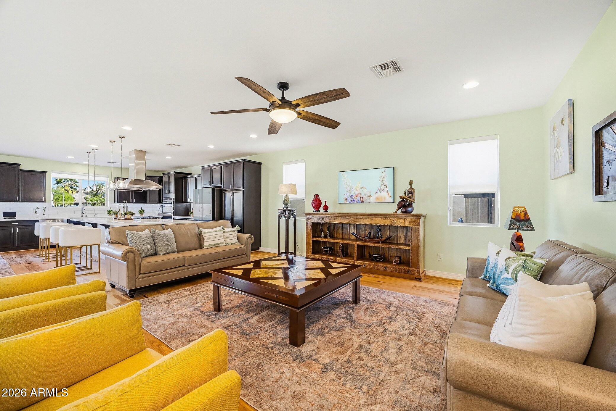 5819 South Wilson Way Gilbert, AZ 85298 - Photo 41 of 76 a living room with furniture a rug and a chandelier