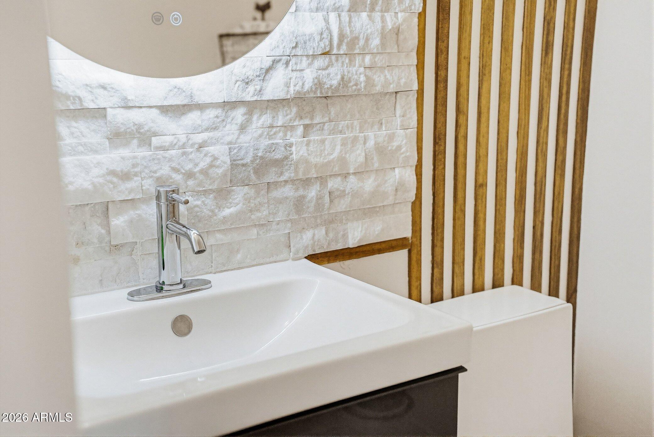 5819 South Wilson Way Gilbert, AZ 85298 - Photo 48 of 76 a bathroom with a sink and a large mirror