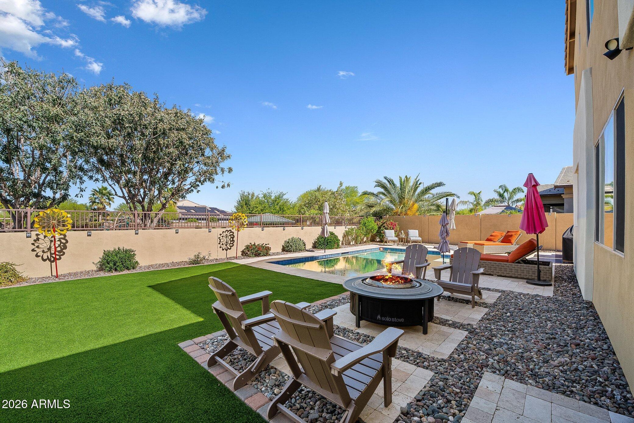 5819 South Wilson Way Gilbert, AZ 85298 - Photo 62 of 76 a backyard of a house with dining table and chairs