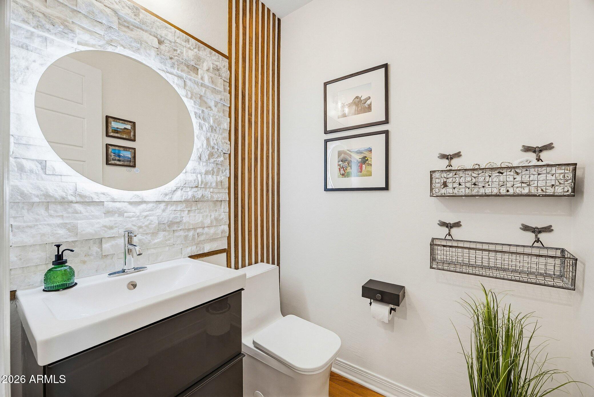5819 South Wilson Way Gilbert, AZ 85298 - Photo 4 of 76 a bathroom with a sink mirror and toilet