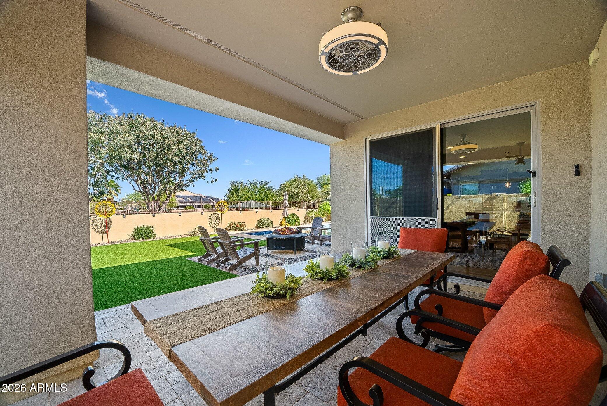 5819 South Wilson Way Gilbert, AZ 85298 - Photo 6 of 76 a living room with furniture floor to ceiling window and a table