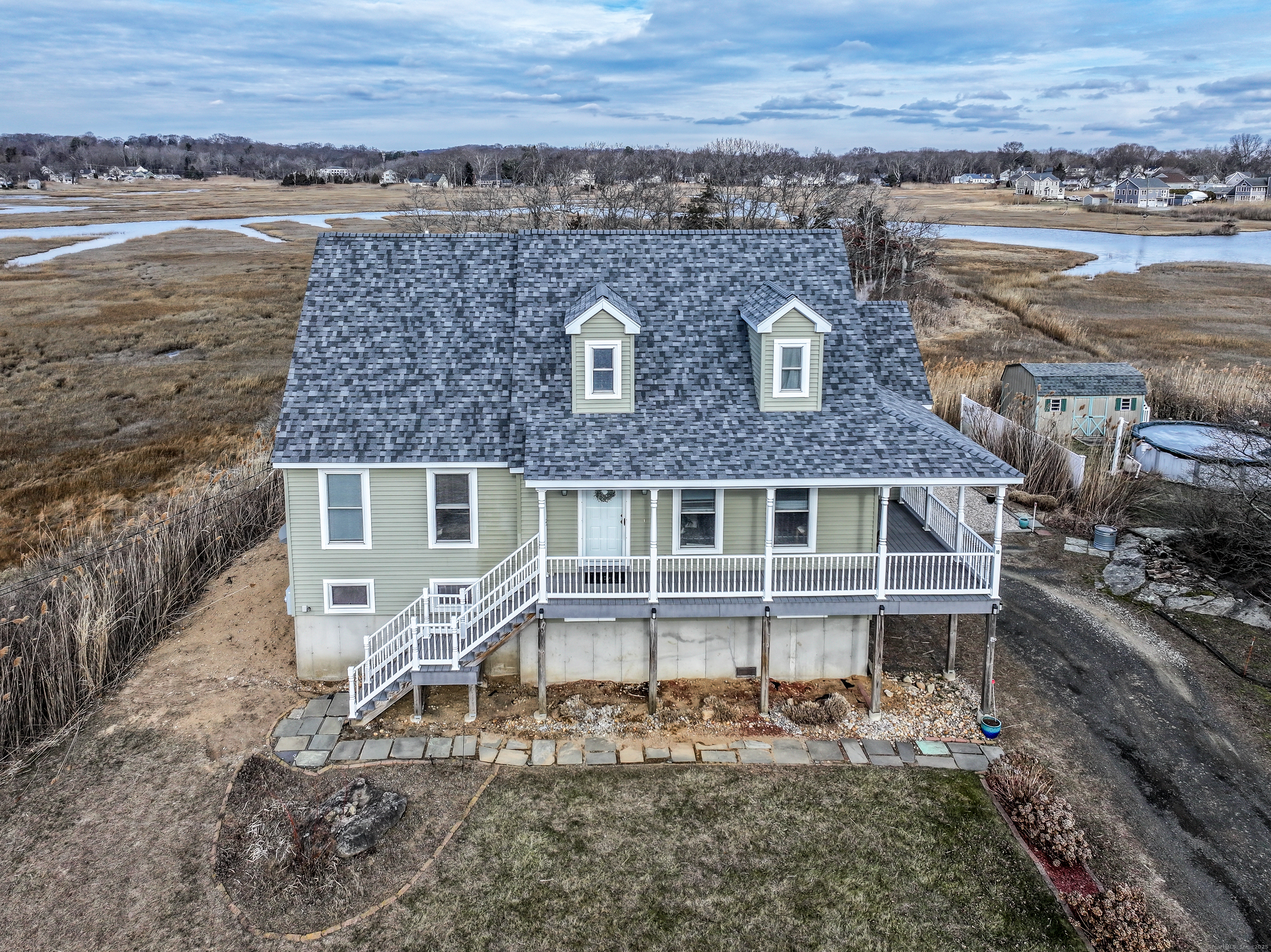 an aerial view of a house with a yard