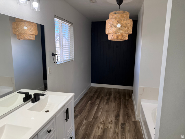 1038 West 950 South Springville, UT 84663 - Photo 12 of 14 Modern bathroom featuring wood-finish flooring, a white dual vanity with matte black fixtures, and a large mirror