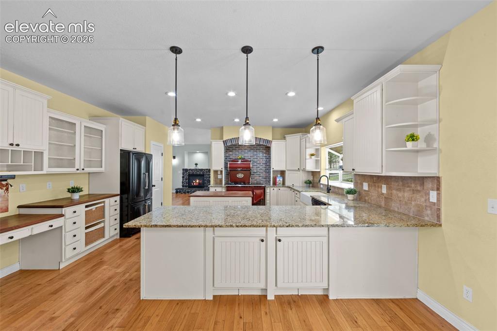 16540 Mesquite Road Peyton, CO 80831 - Photo 12 of 50 a kitchen with kitchen island a counter top space a sink stainless steel appliances and cabinets