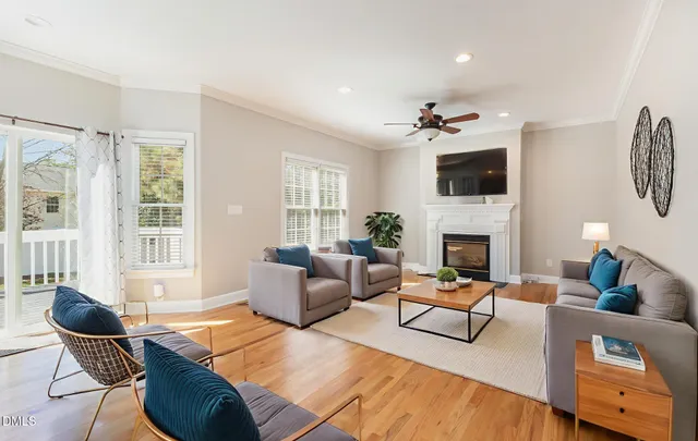 a living room with furniture a fireplace and a flat screen tv