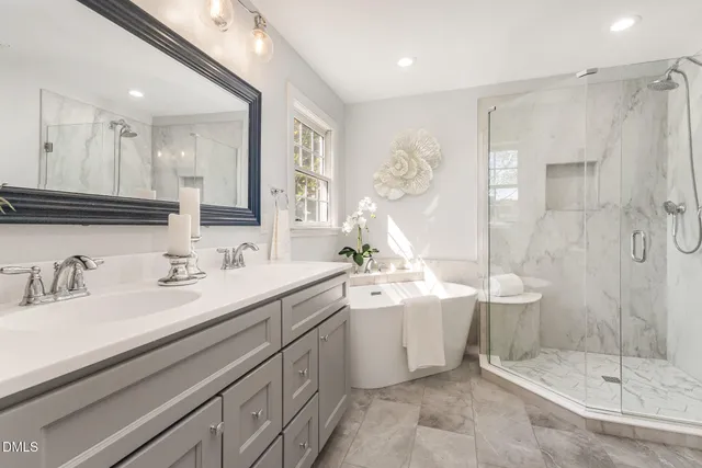 a spacious bathroom with double sink and a mirror