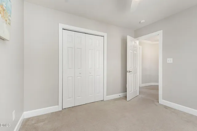 an empty room with closet area