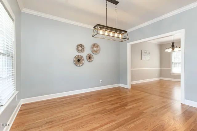 a view of a room with wooden floor and a window