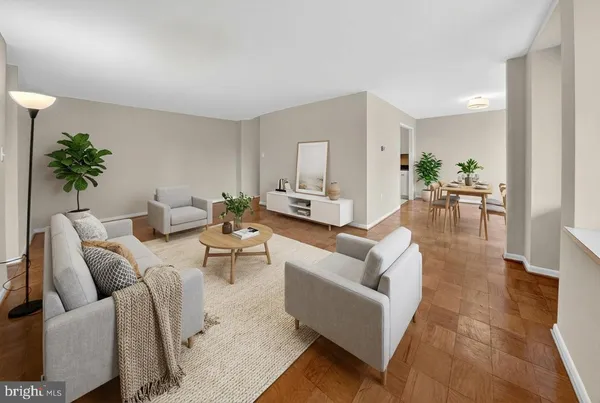a living room with furniture and a potted plant