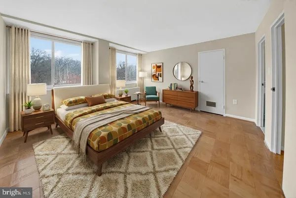 a spacious bedroom with a bed and a large window