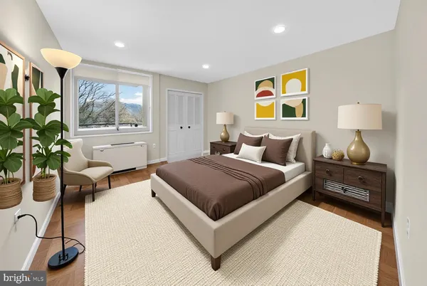 a bedroom with a bed and a potted plant