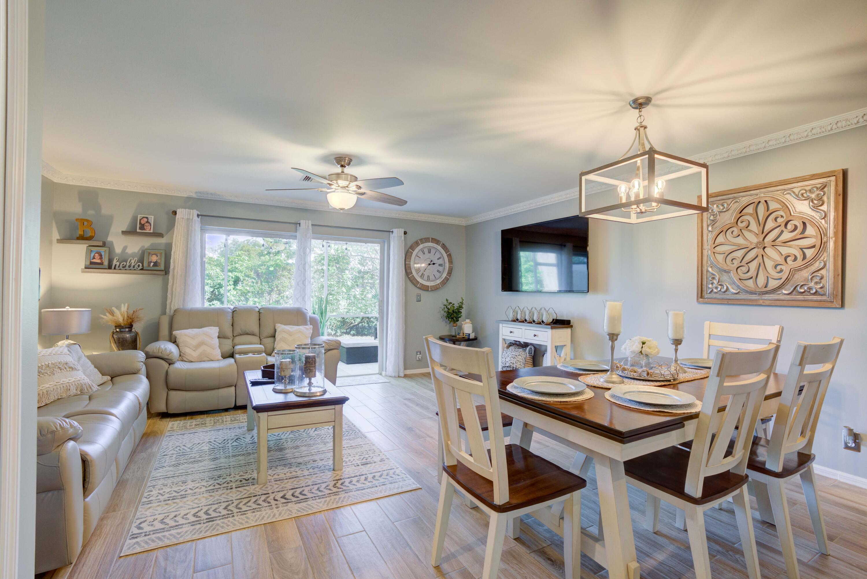 a living room with furniture a window and a chandelier