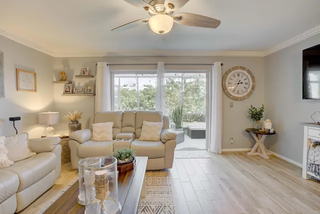a living room with furniture a table and a large window