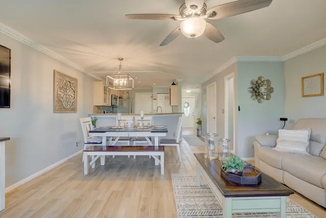 a living room with furniture and a chandelier