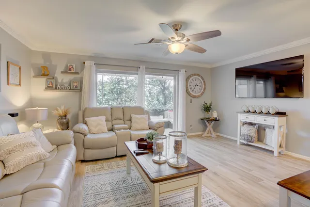 a living room with furniture a fireplace and a flat screen tv