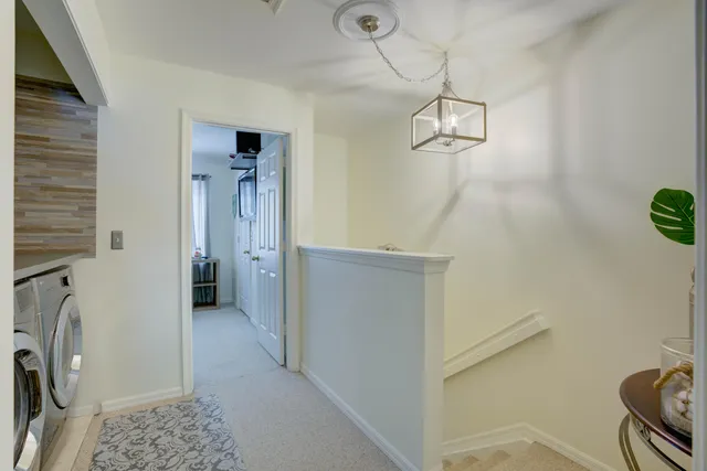 a view of a hallway with washer and dryer