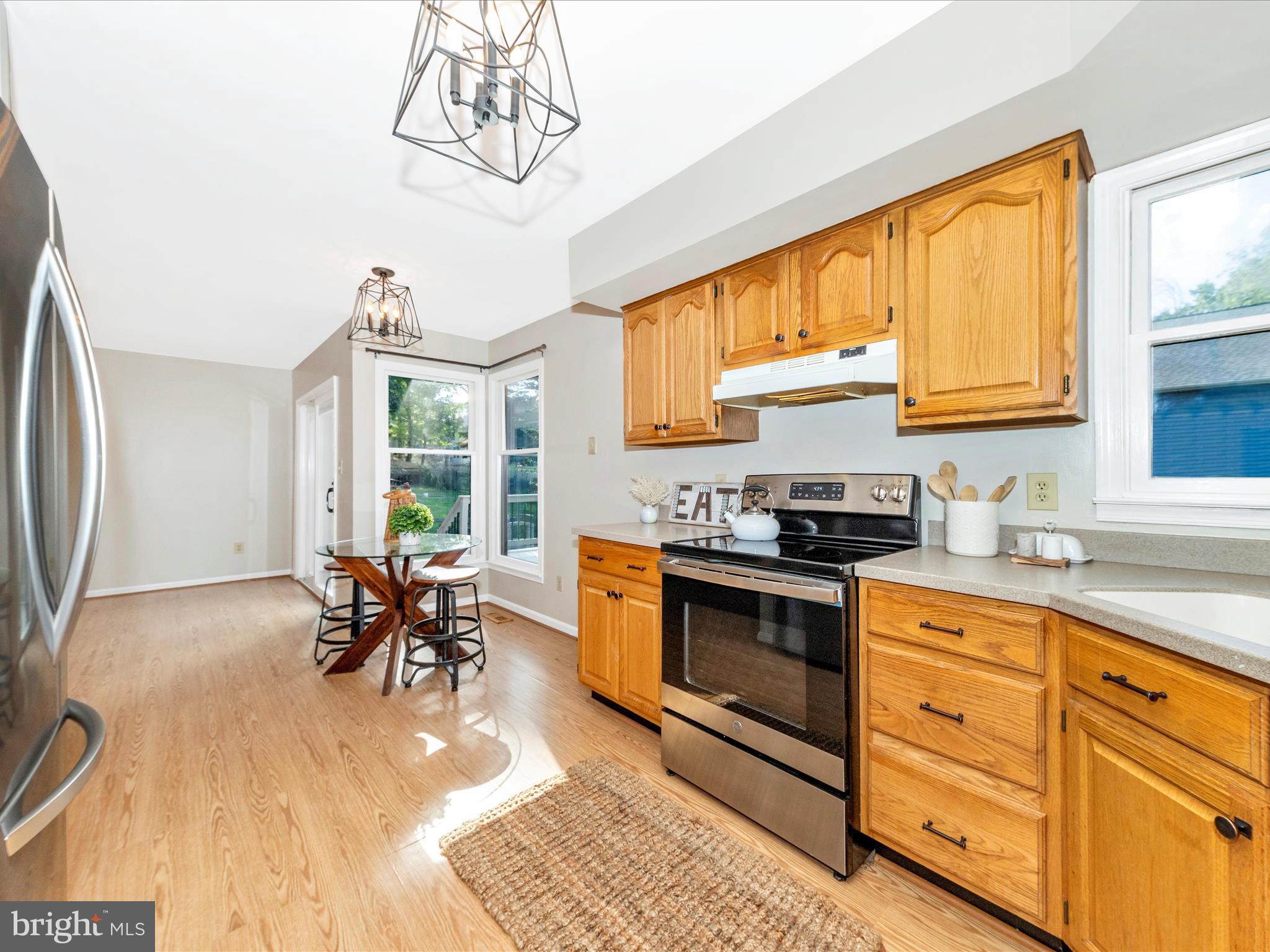 10632 Old Barn Road New Market, MD 21774 - Photo 20 of 76 a kitchen with stainless steel appliances granite countertop a stove a sink and a microwave
