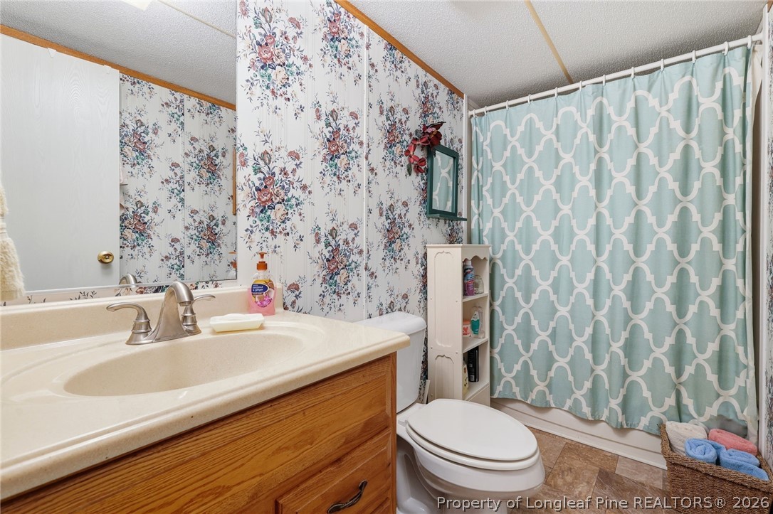 10400 Ruth Vinson Road Autryville, NC 28318 - Photo 48 of 49 a bathroom with a sink toilet and shower