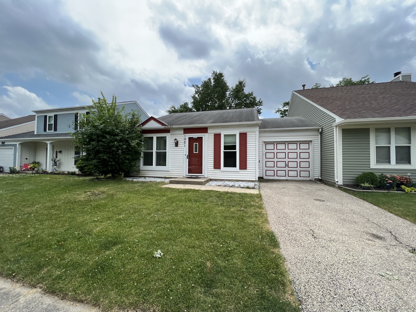 a front view of a house with a garden