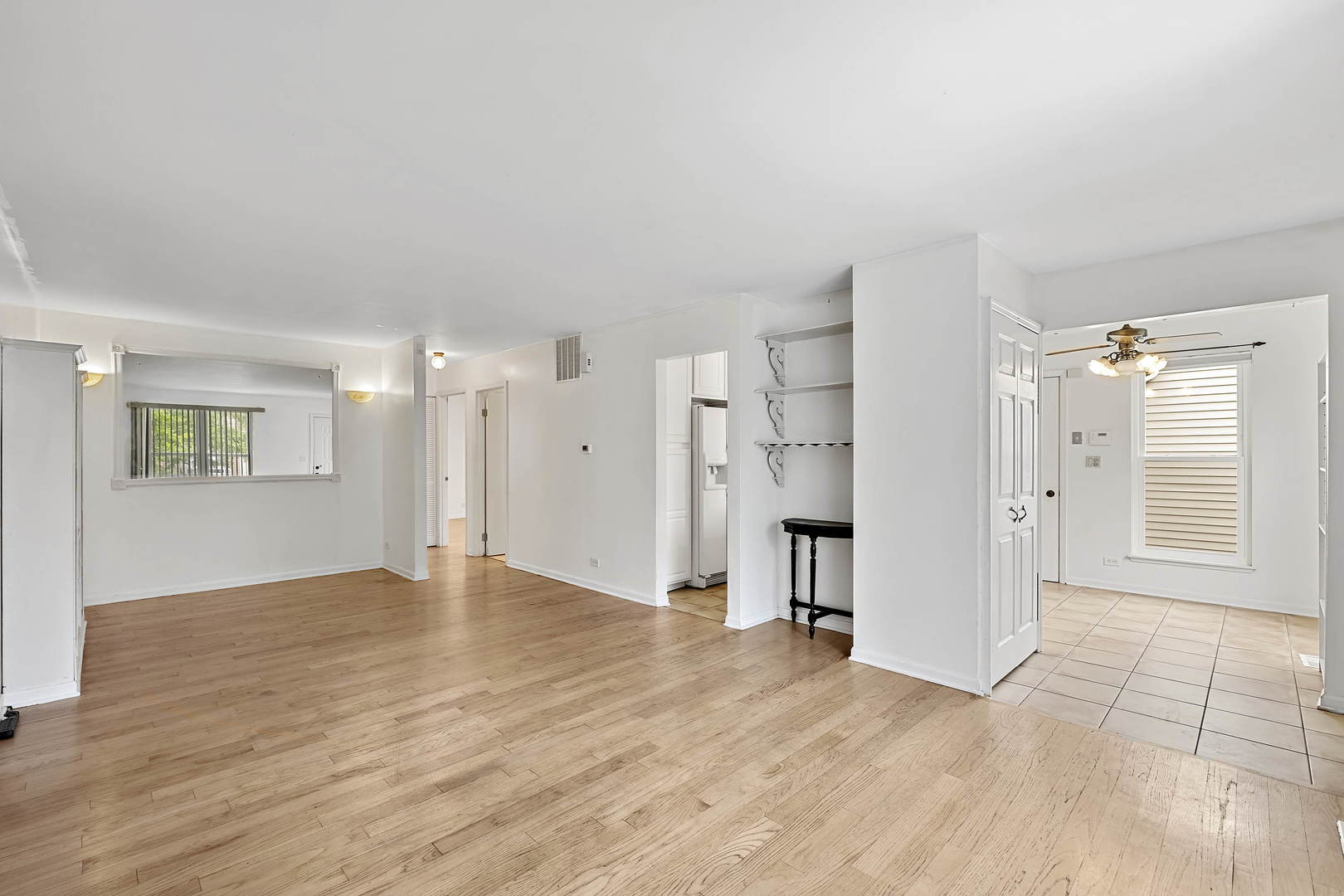 1021 Perry Drive Algonquin, IL 60102 - Photo 4 of 18 a view of a big room with wooden floor and a kitchen