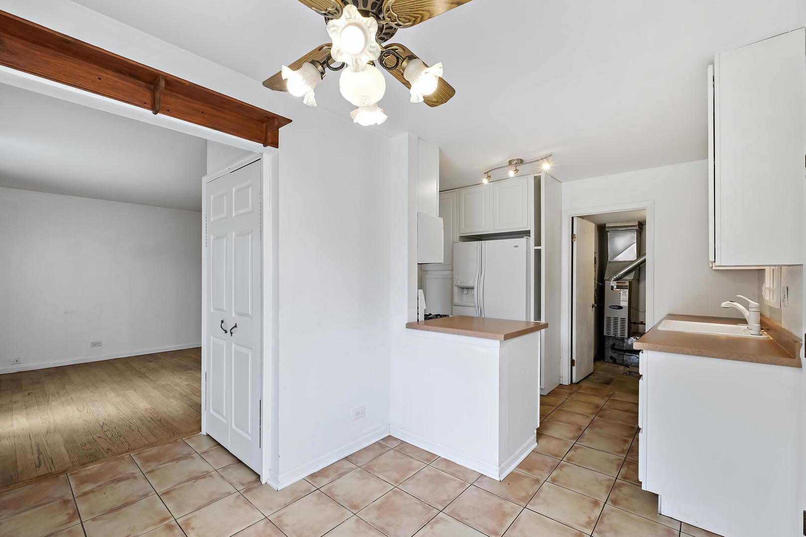 1021 Perry Drive Algonquin, IL 60102 - Photo 9 of 18 a view of a kitchen with fridge and wooden floor