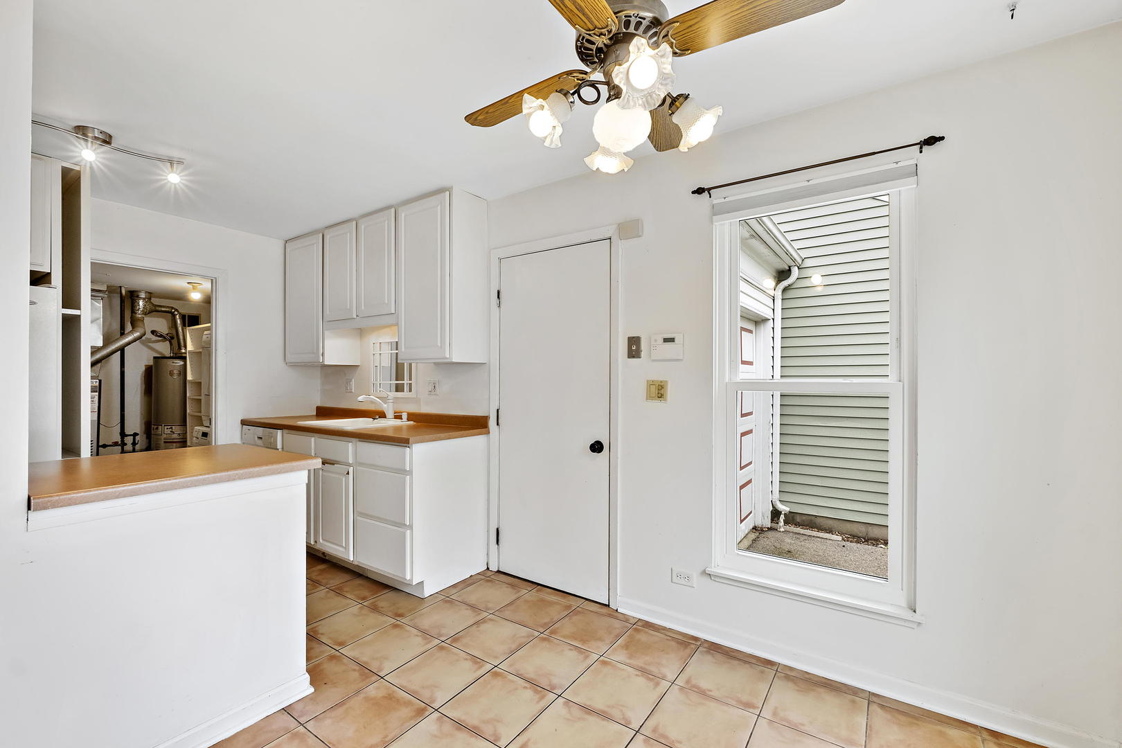 1021 Perry Drive Algonquin, IL 60102 - Photo 10 of 18 a kitchen with stainless steel appliances granite countertop a sink and a refrigerator