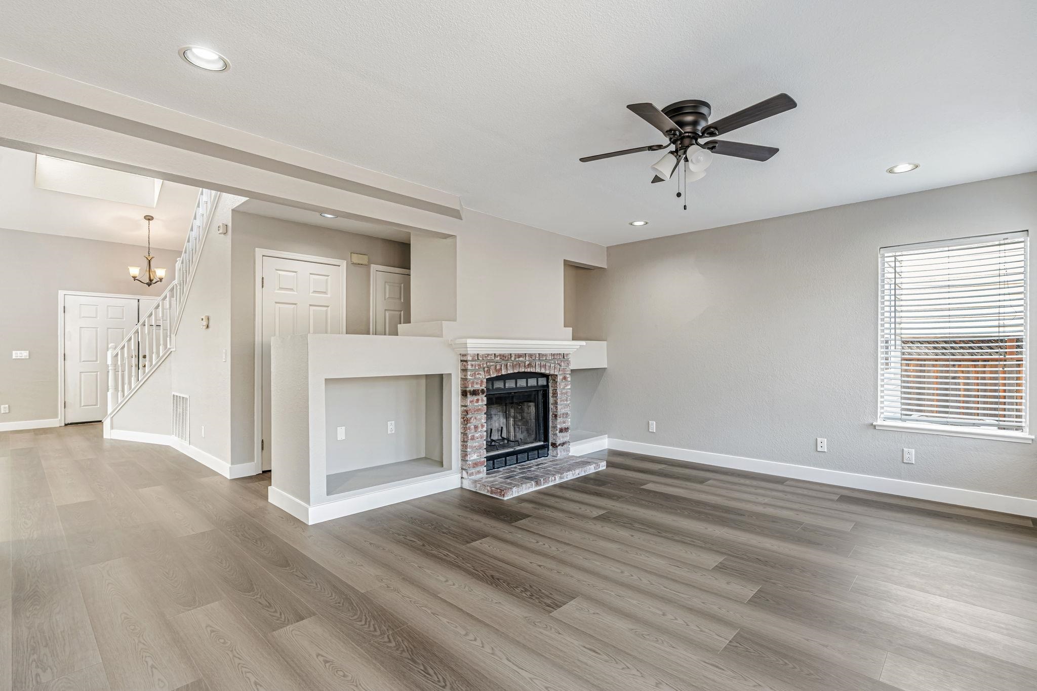 5052 Perry Way Antioch, CA 94531 - Photo 11 of 51 Unfurnished living room featuring a fireplace, recessed lighting, stairway, light wood-style floors, and a ceiling fan