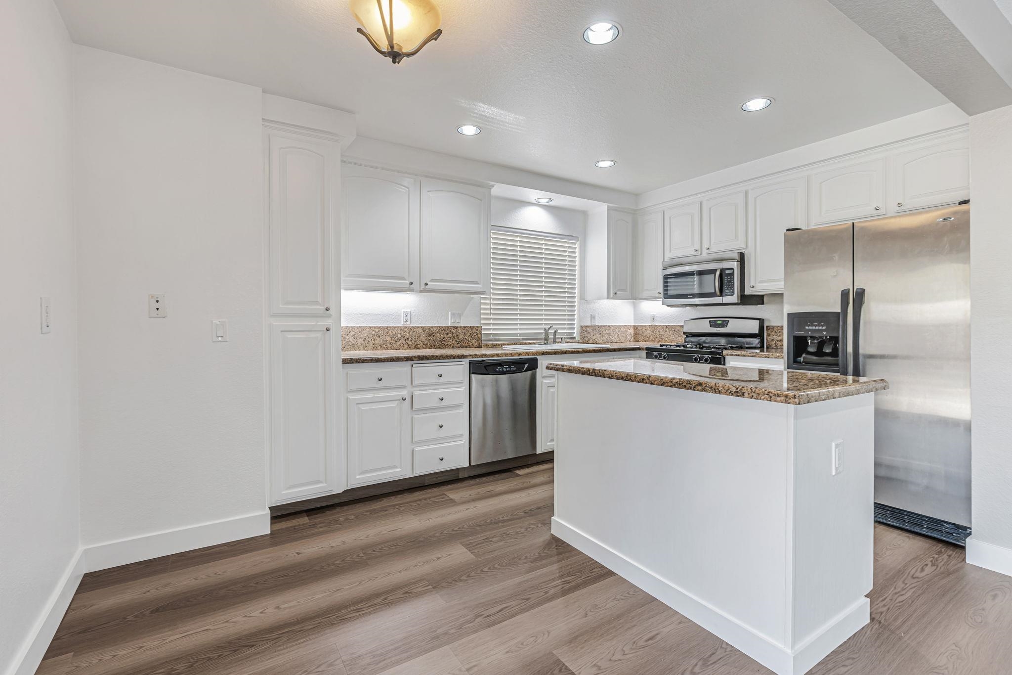 5052 Perry Way Antioch, CA 94531 - Photo 13 of 51 Kitchen with appliances with stainless steel finishes, dark stone counters, white cabinetry, and recessed lighting