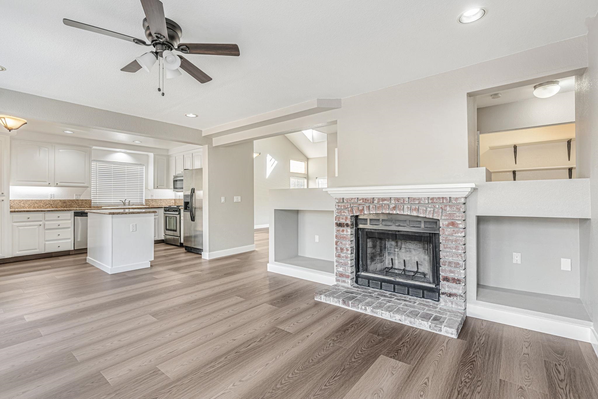 5052 Perry Way Antioch, CA 94531 - Photo 15 of 51 Unfurnished living room featuring ceiling fan, light wood finished floors, recessed lighting, and a fireplace