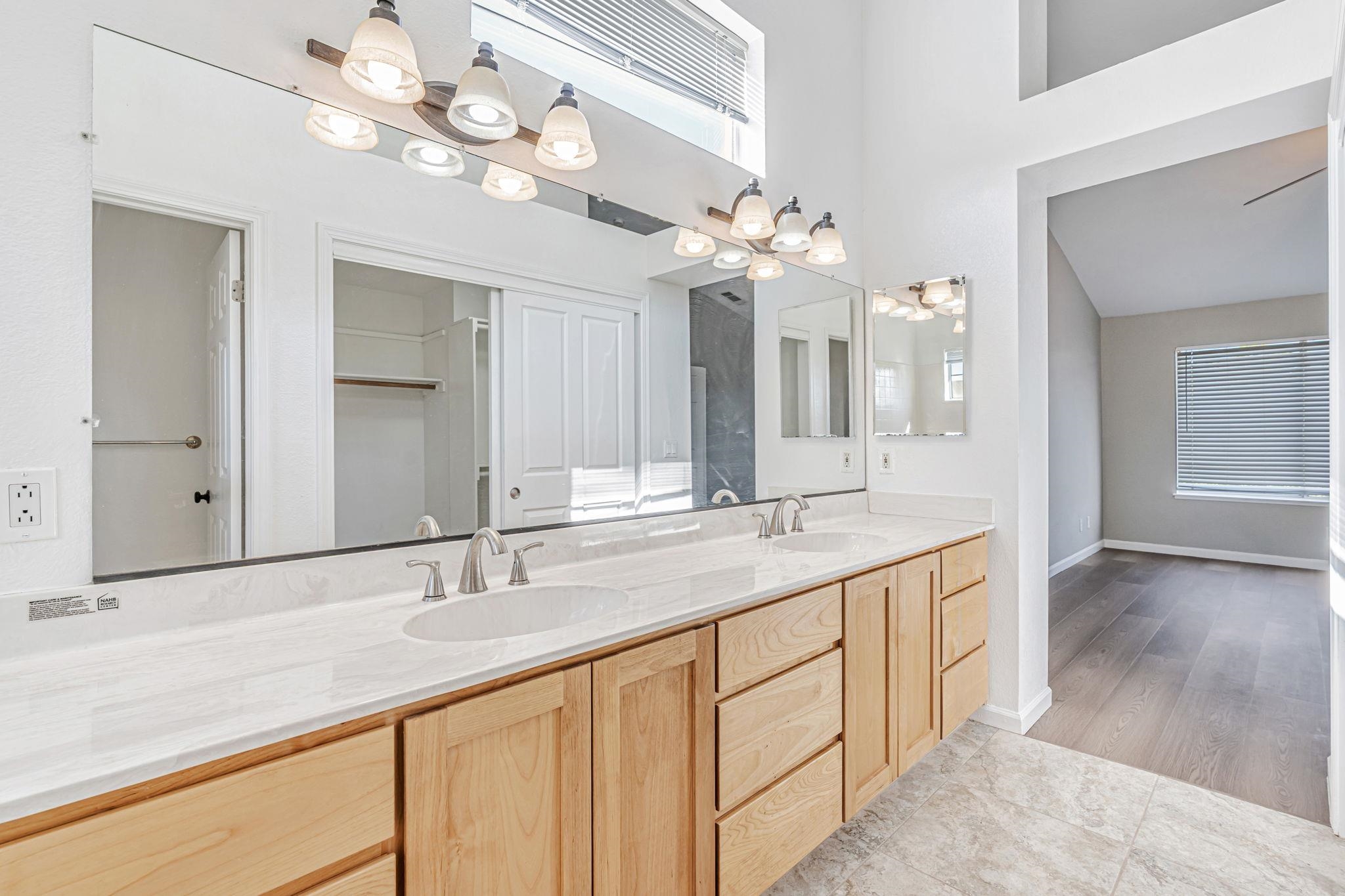 5052 Perry Way Antioch, CA 94531 - Photo 28 of 51 Bathroom featuring double vanity, a chandelier, light tile patterned flooring, and a high ceiling