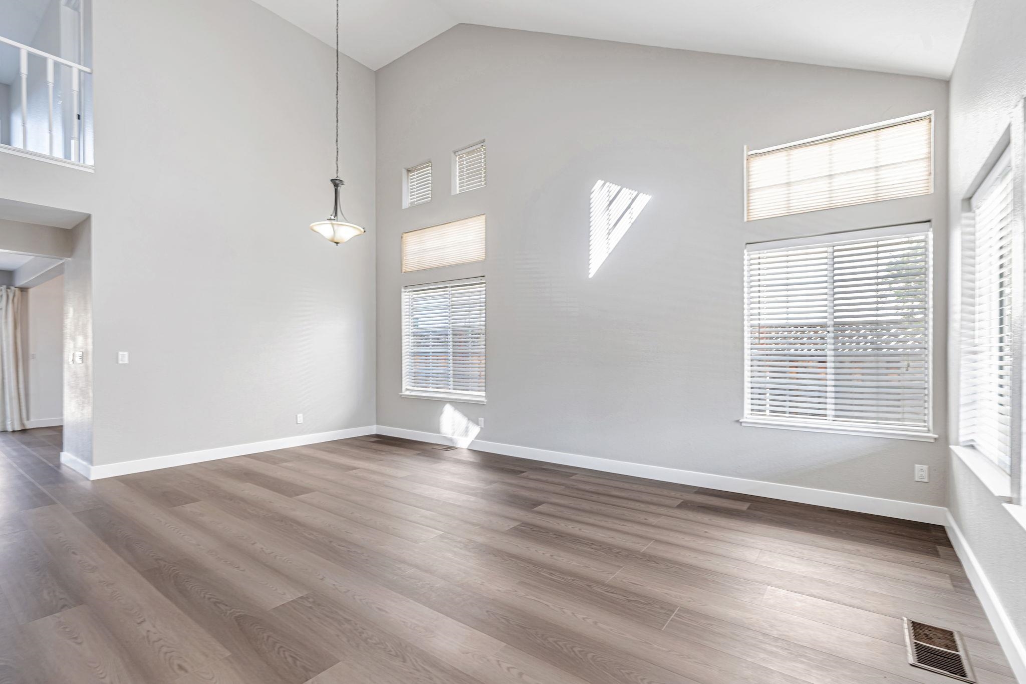 5052 Perry Way Antioch, CA 94531 - Photo 31 of 51 Empty room with wood finished floors and high vaulted ceiling