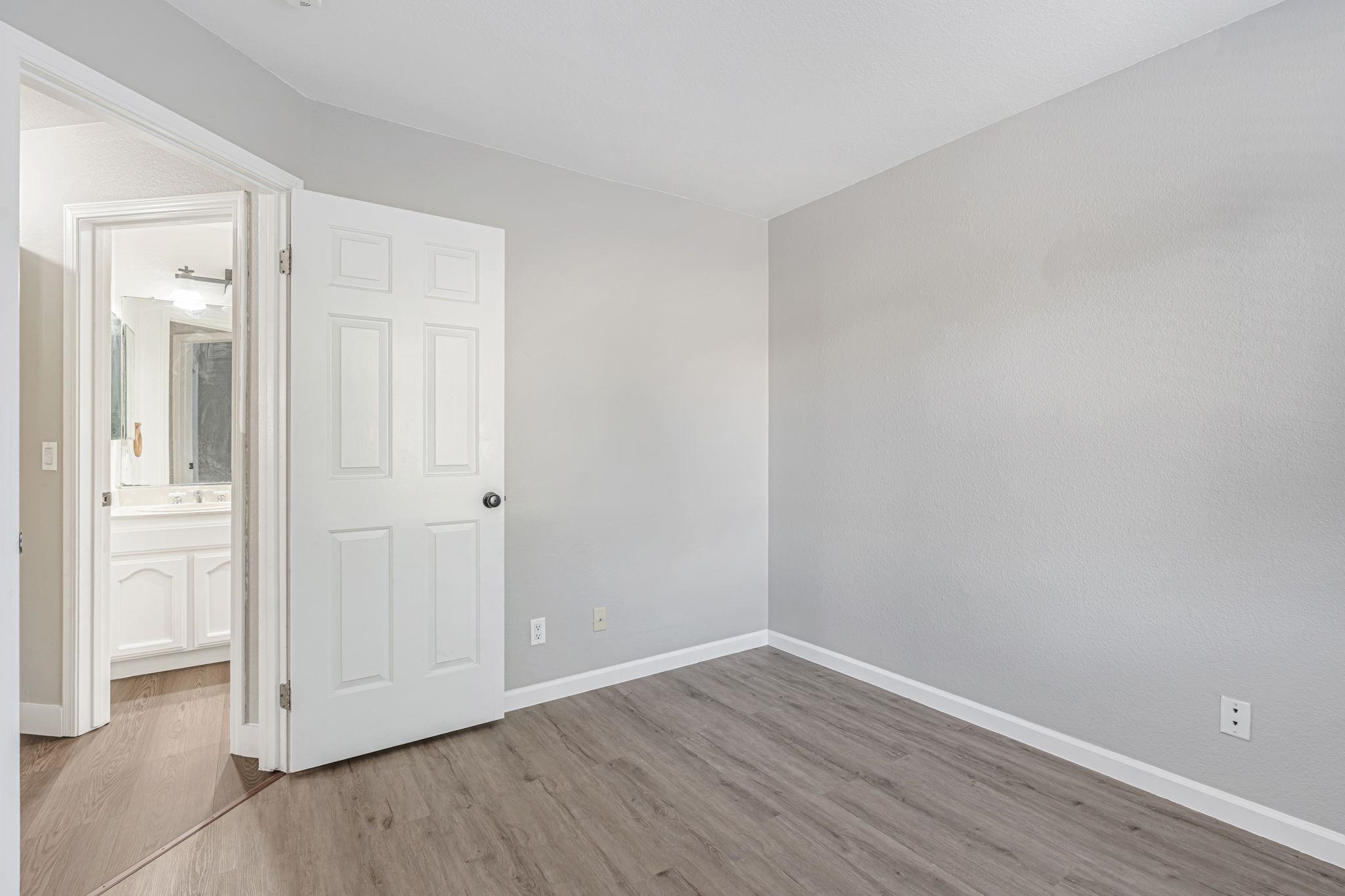 5052 Perry Way Antioch, CA 94531 - Photo 36 of 51 Unfurnished bedroom with wood finished floors and connected bathroom
