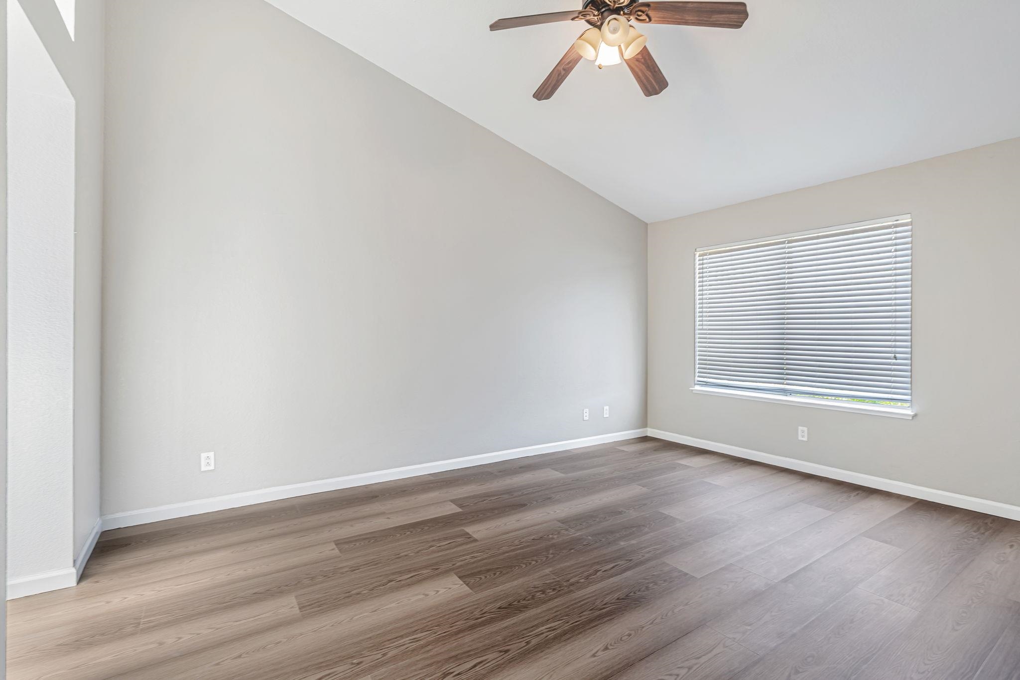 5052 Perry Way Antioch, CA 94531 - Photo 40 of 51 Empty room featuring vaulted ceiling, light wood-type flooring, and ceiling fan