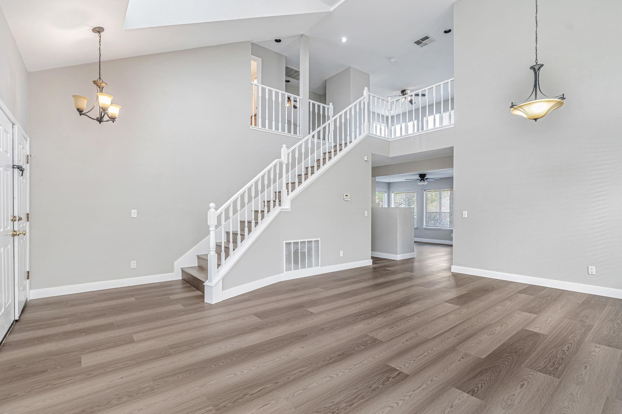 5052 Perry Way Antioch, CA 94531 - Photo 5 of 51 Foyer with light wood-style floors, stairs, high vaulted ceiling, a chandelier, and a skylight