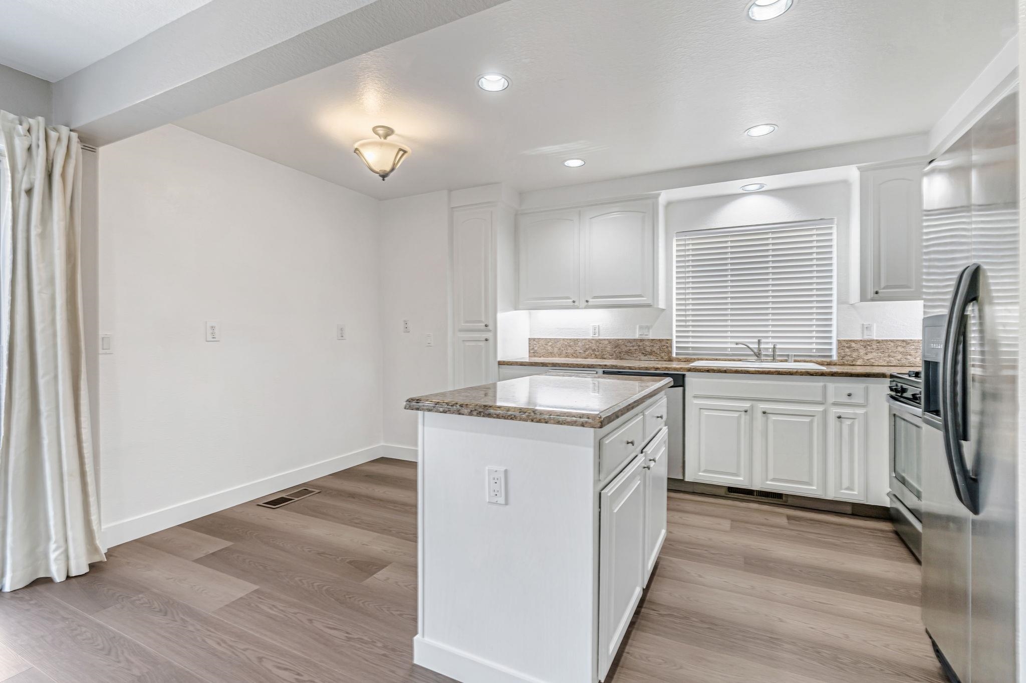 5052 Perry Way Antioch, CA 94531 - Photo 9 of 51 Kitchen with light stone counters, light wood-style floors, white cabinetry, and recessed lighting